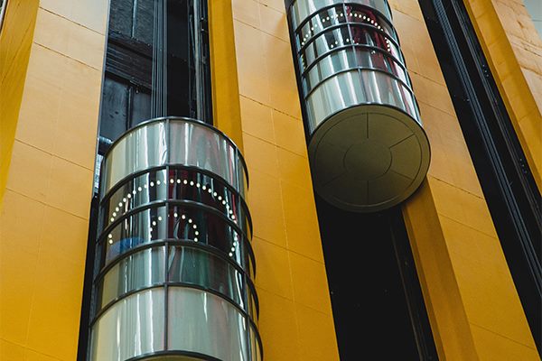 Glass capsule elevators on a commercial building facade